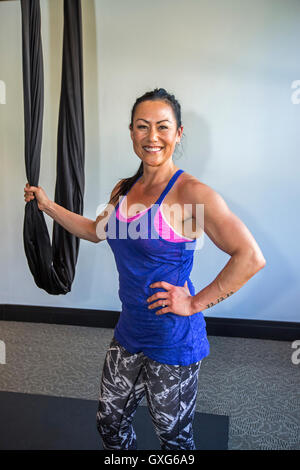 Mixed Race woman posing with hanging silks Stock Photo