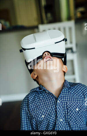 Caucasian boy wearing virtual reality goggles Stock Photo