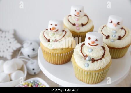 Fun homemade melting snowman cupcakes for kids Stock Photo