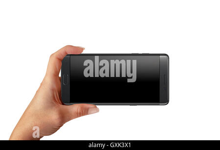 Playing game ot taking photo with modern smart phone with blank screen for mockup. Woman hold phone in horizontal position. Stock Photo