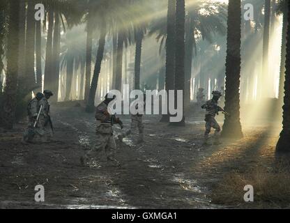 Iraqi Army Division Baghdad Eagles soldiers patrol the muddied palm grove grounds south of the Iraqi capital February 17, 2007 in Mahmudiayh, Iraq. Stock Photo