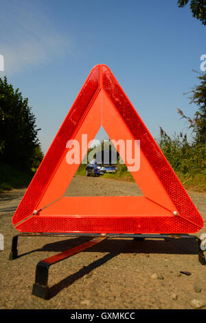 hazard warning triangle by broken down car on country road near york yorkshire uk Stock Photo