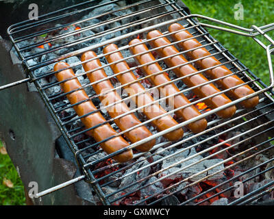 Barbecue sausages on the grill over the coals Stock Photo
