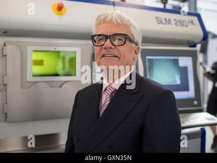 Duesseldorf, Germany. 14th Sep, 2016. The manager of the Austrian steel company Voestalpine, Wolfgang Eder, stands in front of a so-called laser metal bath matchine at the opening of a new research centre for metal 3D printing in Duesseldorf, Germany 14 September 2016. oto: Wolfram Kastl/dpa/Alamy Live News Stock Photo