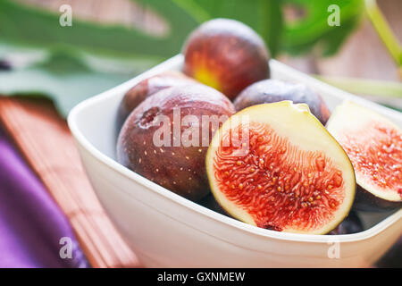 Closeup of fresh ripe black figs in white bowl Stock Photo
