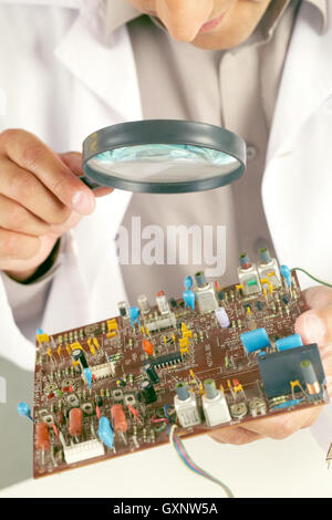 Examining circuit board Stock Photo