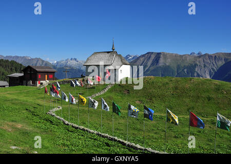 Bettmeralp church and flags in the Swiss Alps, Valais, Switzerland Stock Photo