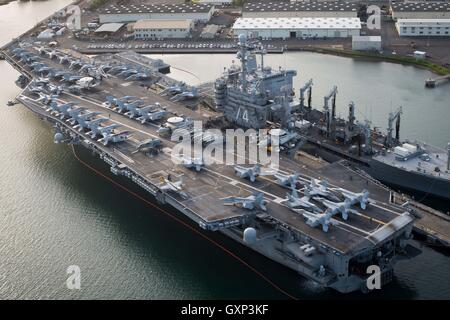 An aerial view of USN Nimitz-class aircraft carrier USS John C. Stennis moored at the Joint Base Pearl Harbor-Hickam April 8, 2016 near Honolulu, Hawaii in preparation for the Rim of the Pacific exercise. RIMPAC occurs from June 30, 2016 to August 4, 2016 in the Pacific Ocean. Stock Photo