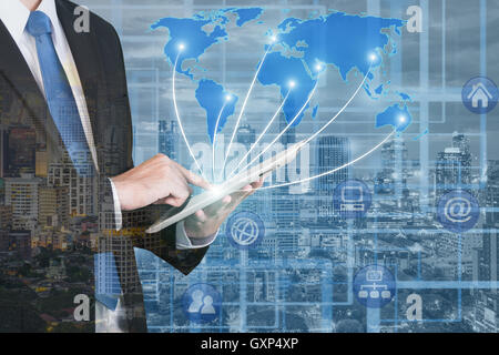 Double exposure of business man using digital tablet with blur city night and global business network connection map.Network con Stock Photo
