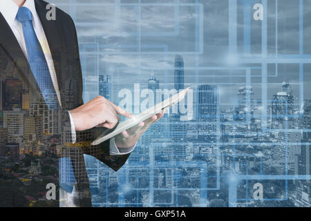 Double exposure of businessman using digital tablet with blur city night and network connection concept Stock Photo