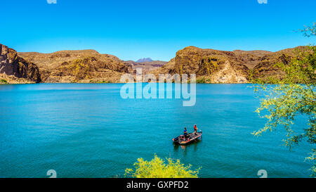Fishing on Canyon Lake surrounded by the Desert Landscape of Tonto National Forest along the Apache Trail in Arizona, USA Stock Photo
