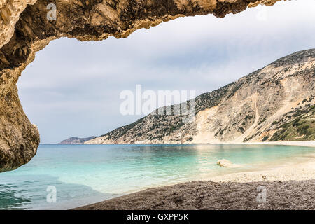 Cave outlook on cove with  sea mountain and gravel beach Stock Photo