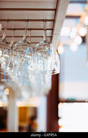 Glasses Hanging Over Bar Rack. Glasses For Wine Above A Bar Rack Stock Photo