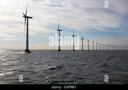 Middelgrunden Offshore Wind Farm outside Copenhagen. The Øresund Bridge to Sweden left in distance. HOFOR and Middelgrundens Wind Turbine Cooperative. Stock Photo