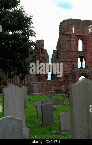 Lindisfarne Priory and churchyard, Holy Island, Northumberland coast, Northeast England, UK Stock Photo