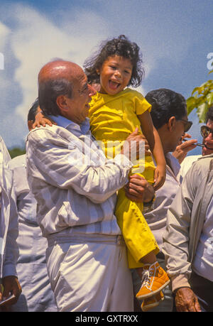 CIUDAD GUAYANA, VENEZUELA - Presidential candidate Carlos Andres Perez campaigning, picks up young girl, October1988. Stock Photo