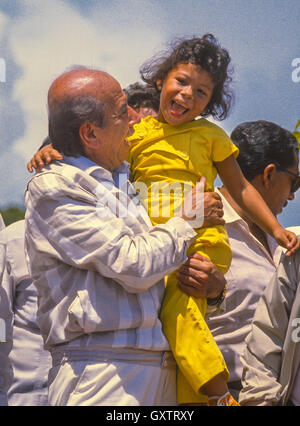 CIUDAD GUAYANA, VENEZUELA - Presidential candidate Carlos Andres Perez campaigning, picks up young girl. 1988 Stock Photo