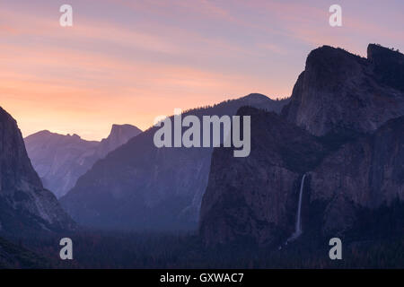 Bridalveil Falls and Half Dome at sunrise from Tunnel View, Yosemite Valley, California, USA. Spring (June) 2016. Stock Photo