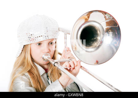 young girl with cap playing trombone Stock Photo