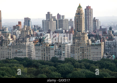 Buildings on Upper East Side rise above the trees in Central Park Stock Photo