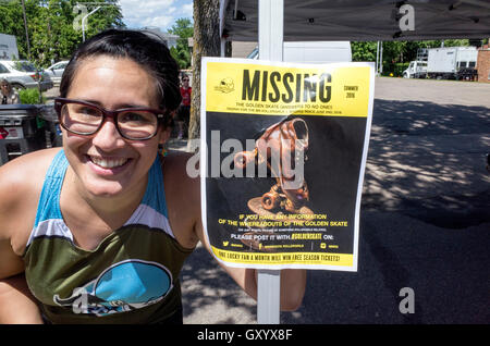 MN Rollergirl stands by poster requesting return of Golden Skate Trophy at Grand Old Days booth. St Paul Minnesota MN USA Stock Photo