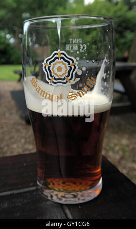 Glass Half Full,Samuel Smith pint glass, Vine Inn, Dunham, Altrincham,Cheshire,England,UK Stock Photo