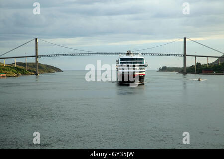 Hurtigruten ship 'Trollfjord' arriving at port of Rorvik, Norway with road bridge Stock Photo