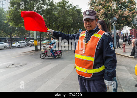 Chinese Traffic Warden is working at intersection in Xian, Shaanxi Province, China. Stock Photo