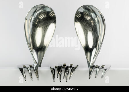 Metal spoons and three forks formed into two conceptual fantasy figures Stock Photo