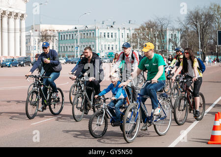 Gomel, Belarus - April 10, 2015: Group of young people cyclists ride on street at opening of the cycling season in the city Stock Photo