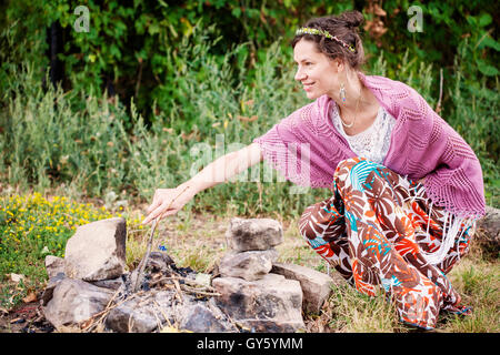 Romantic woman in crocheted plaid in nature Stock Photo