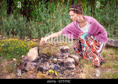 Romantic woman in crocheted plaid in nature Stock Photo