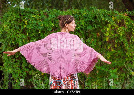 Romantic woman in crocheted plaid in nature Stock Photo