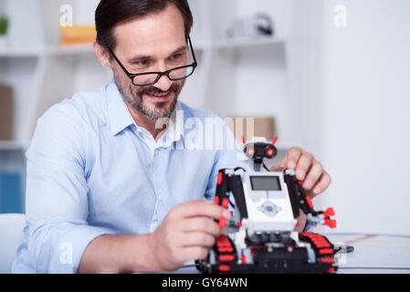 Smart scientist working on a robot production Stock Photo