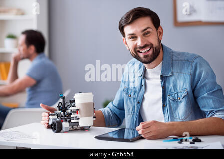 Joyful man testing robot Stock Photo