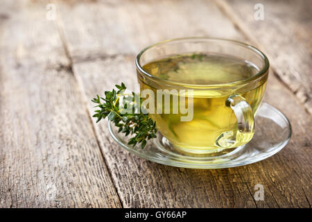 cup of thyme tea, fresh thyme on the old wooden background Stock Photo