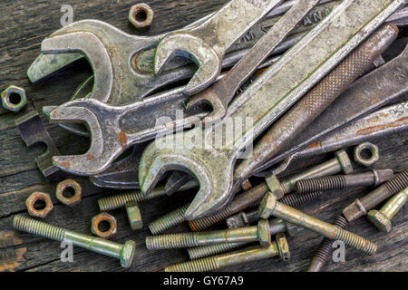 Old,rusted wrenches bolts and nuts on table Stock Photo