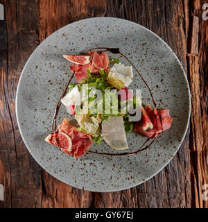 Fresh salad with figs, prosciutto and goat cheese Stock Photo