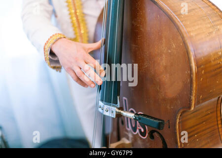 the man plays a contrabass. Stock Photo