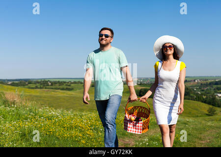 Young couple going with picnic basket Stock Photo