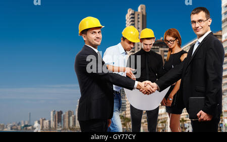 Business people shaking hands, finishing up a meeting. Construction theme Stock Photo