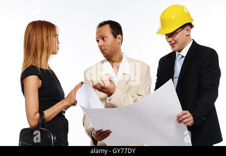Married couple and architect looking to the blueprint and discussing about the house construction plan Stock Photo