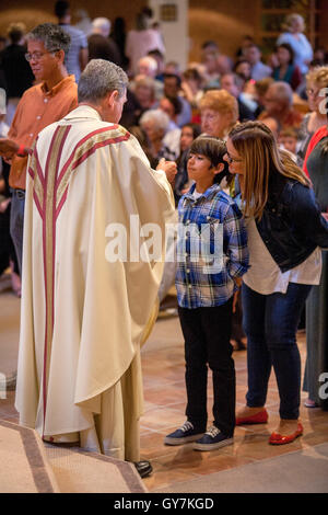 Children take communion after mass at a Laguna Niguel, CA, Catholic church. Stock Photo