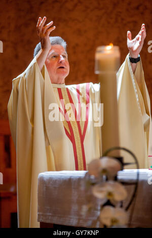 Wearing formal robes, a monsignor conducts mass at a Laguna Niguel, CA ...