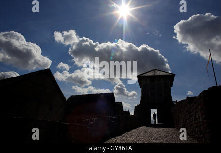 Tilleda, Germany. 29th Aug, 2016. A man walks through the pincer gate at the Tilleda royal palace in Tilleda, Germany, 29 August 2016. It was determined during excavations that the former mediaeval royal palace was twice as large as previously thought. In 972 Emperor Otto II (955-983) gave the area of the Tilleda royal palace to his wife, the Byzantine princess Theophano, as a dowry. With a surface of 4 hectares, Tilleda is the largest archaeological open-air museum in Saxony-Anhalt today. Photo: JAN WOITAS/dpa/Alamy Live News Stock Photo