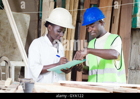 teacher tells his student to write in a notebook what she learns. Stock Photo