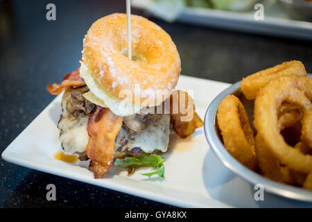 A bacon donut burger (Luther Burger) from Soda Jerks restaurant in Edmonton, Alberta, Canada. Stock Photo