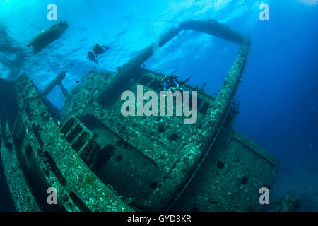 Underwater photographer and scuba divers explore the shipwreck, Giannis D, in the Red Sea off the coast of Egypt. Stock Photo