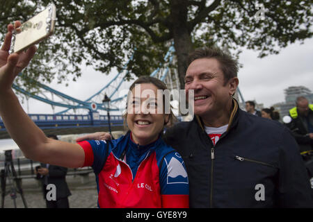Cyclist Sara-Jane Skinner takes a selfie with ambassador for the Blue Marine Foundation Simon Le Bon, at the start of the Blue Marine Foundation London to Monaco Bike Challenge, at The Tower of London, where over 50 cyclists begin the 1500 km in aid of ocean conservation. Stock Photo