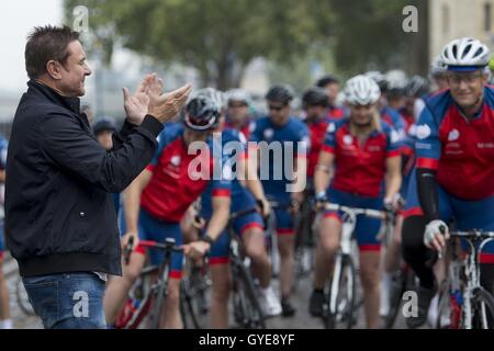 Ambassador for the Blue Marine Foundation Simon Le Bon (left) cheers on cyclists at the start of the Blue Marine Foundation London to Monaco Bike Challenge, at The Tower of London, where over 50 cyclists begin the 1500 km in aid of ocean conservation. Stock Photo